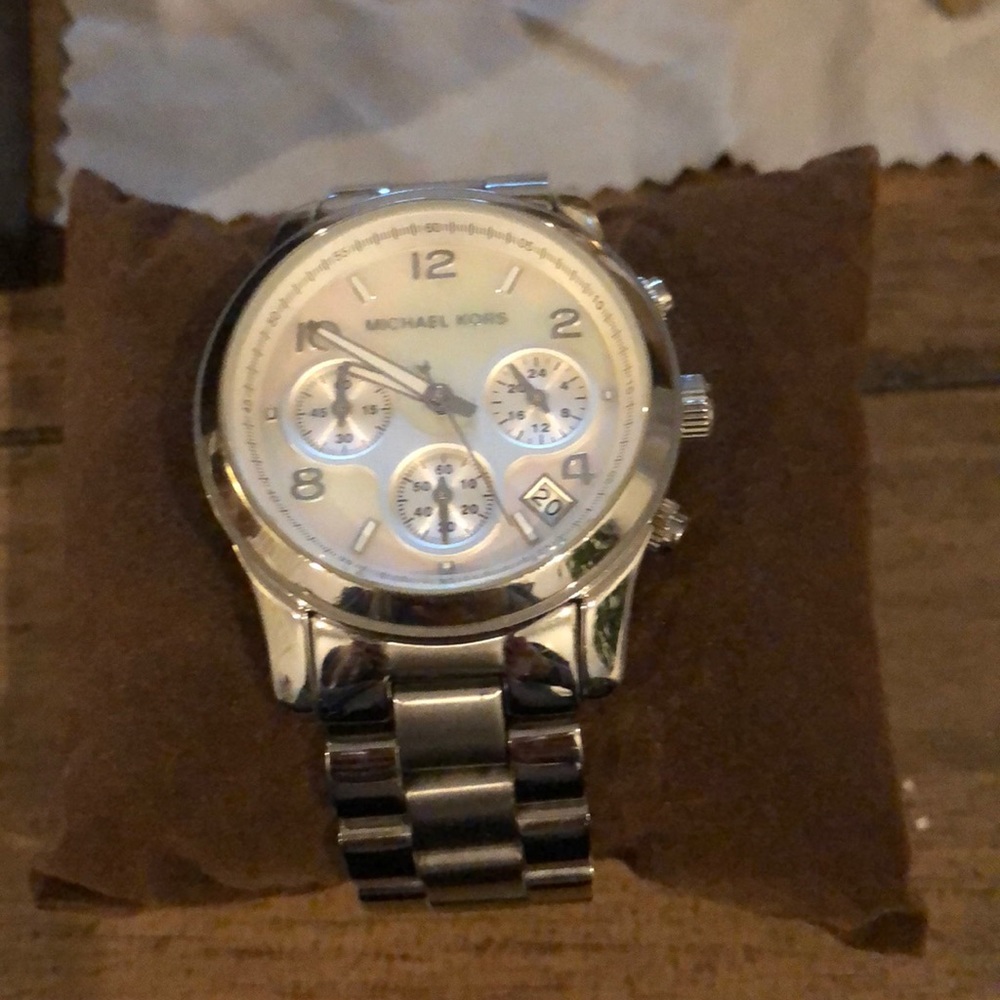 Michael Kors watch. (Silver OR gold one.  Or you can buy both)